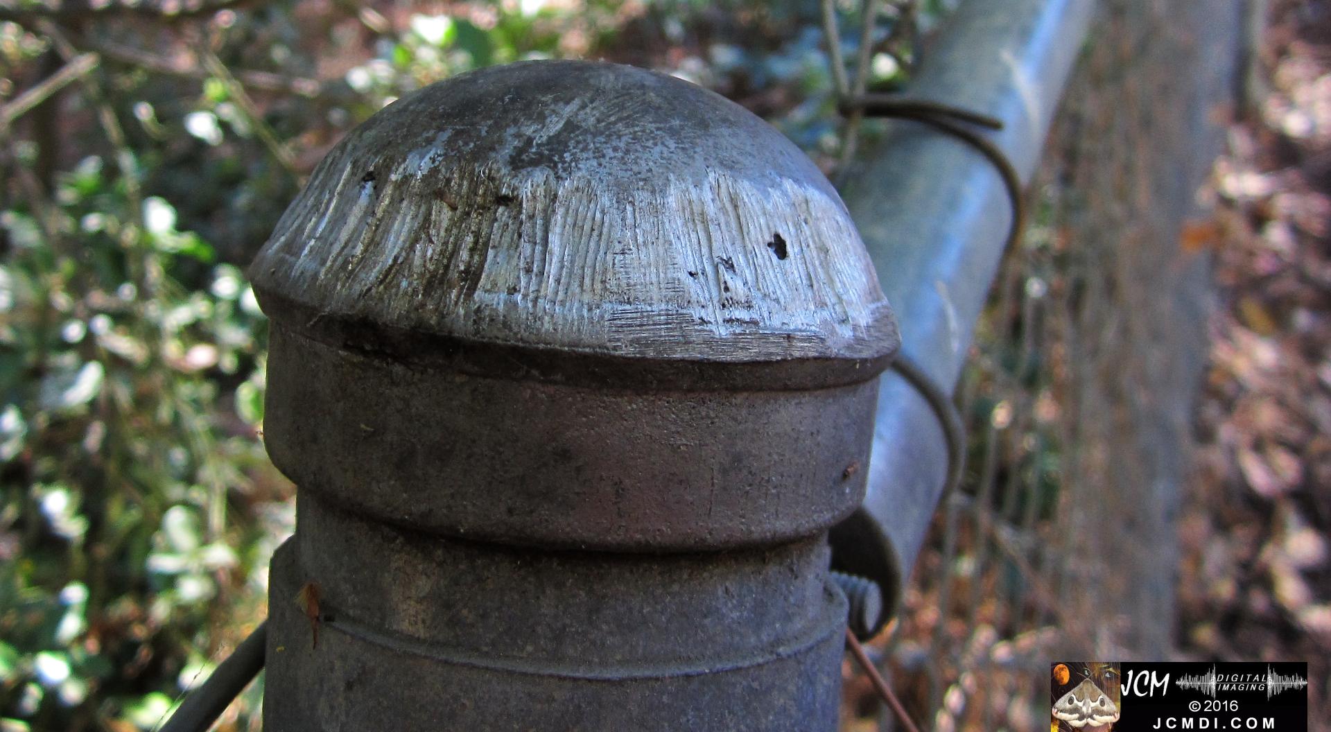 Squirrel gnaw marks on galvanized steel fence post cap JCMDI.COM